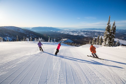 Skiers making their way down the mountain at Ski Whitefish.