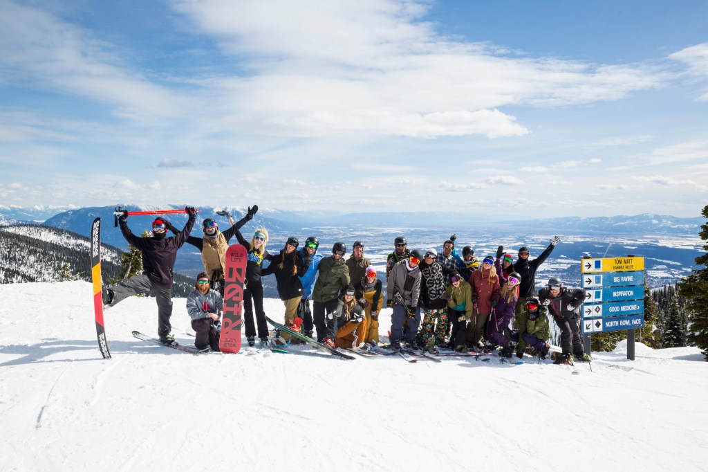 Skiers celebrate reaching the summit at Ski Whitefish.