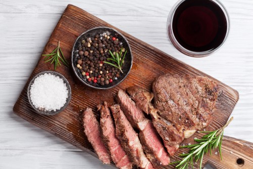 Grilled beef steak with spices on cutting board