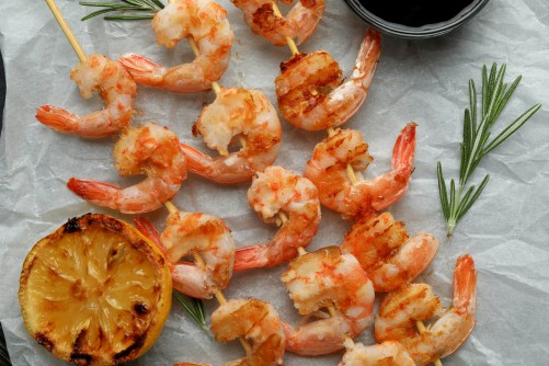 Tasty grilled shrimps on rustic wooden background