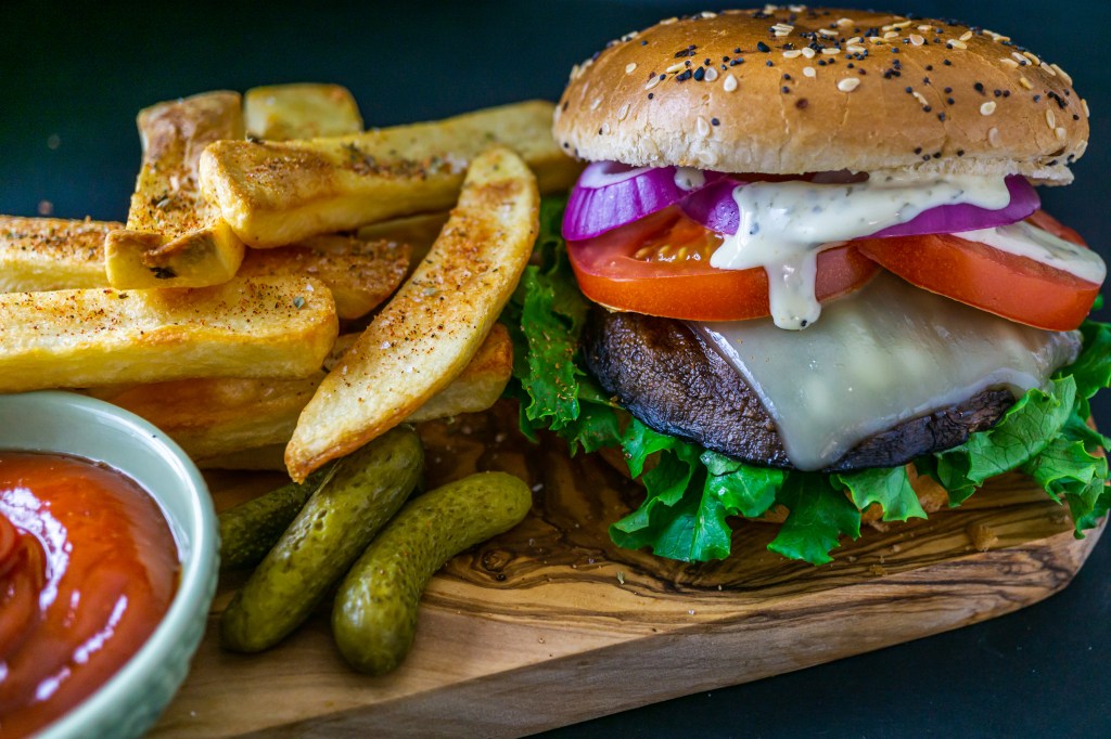 Portobello mushroom burger with fries, gherkins and ketchup