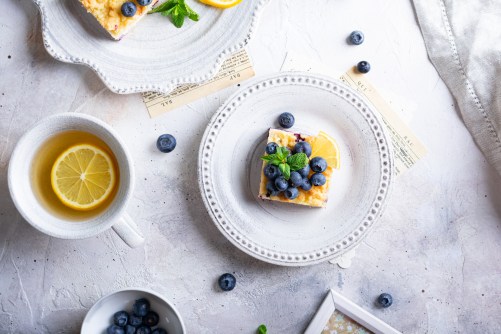 Flat lay of cake with blueberries and cottage cheese