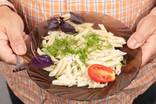 On a plate of pasta, tomato basil and dill.