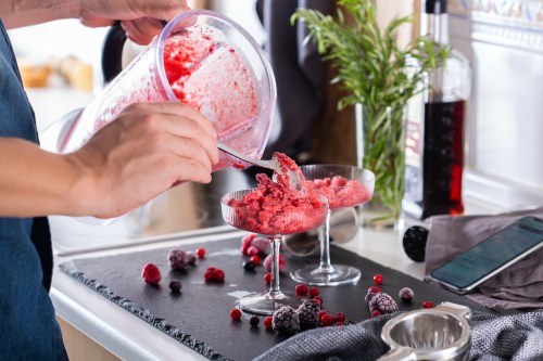 Mixologist making refreshing slushy or slushie cocktail at home